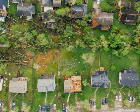 An aerial view of a housing neighborhood destroyed by a tornado.