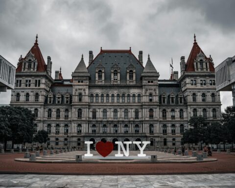 A historic building in Albany, New York, with an "I Love NY" sign in front.