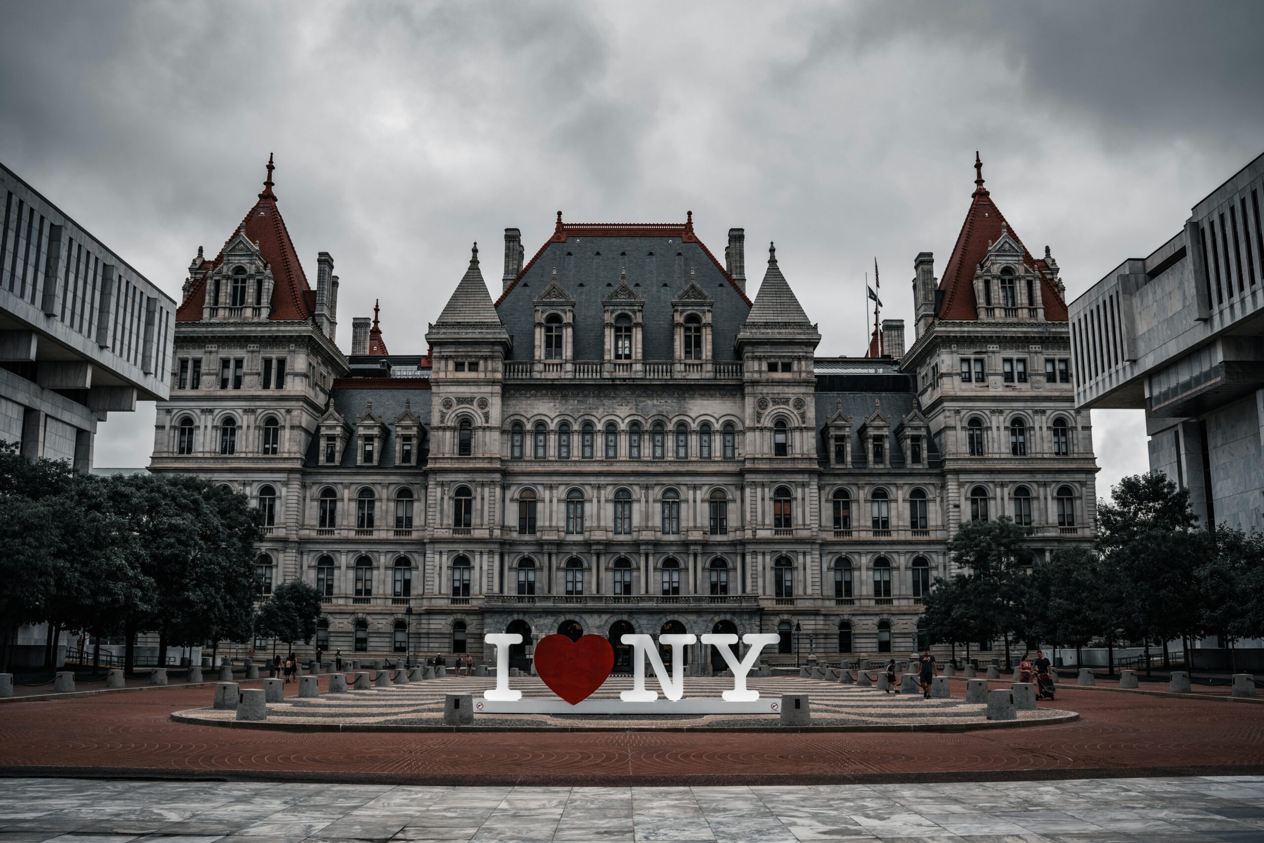 A historic building in Albany, New York, with an "I Love NY" sign in front.