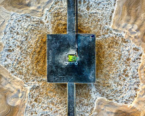 A wastewater treatment facility full of water from an aerial perspective.
