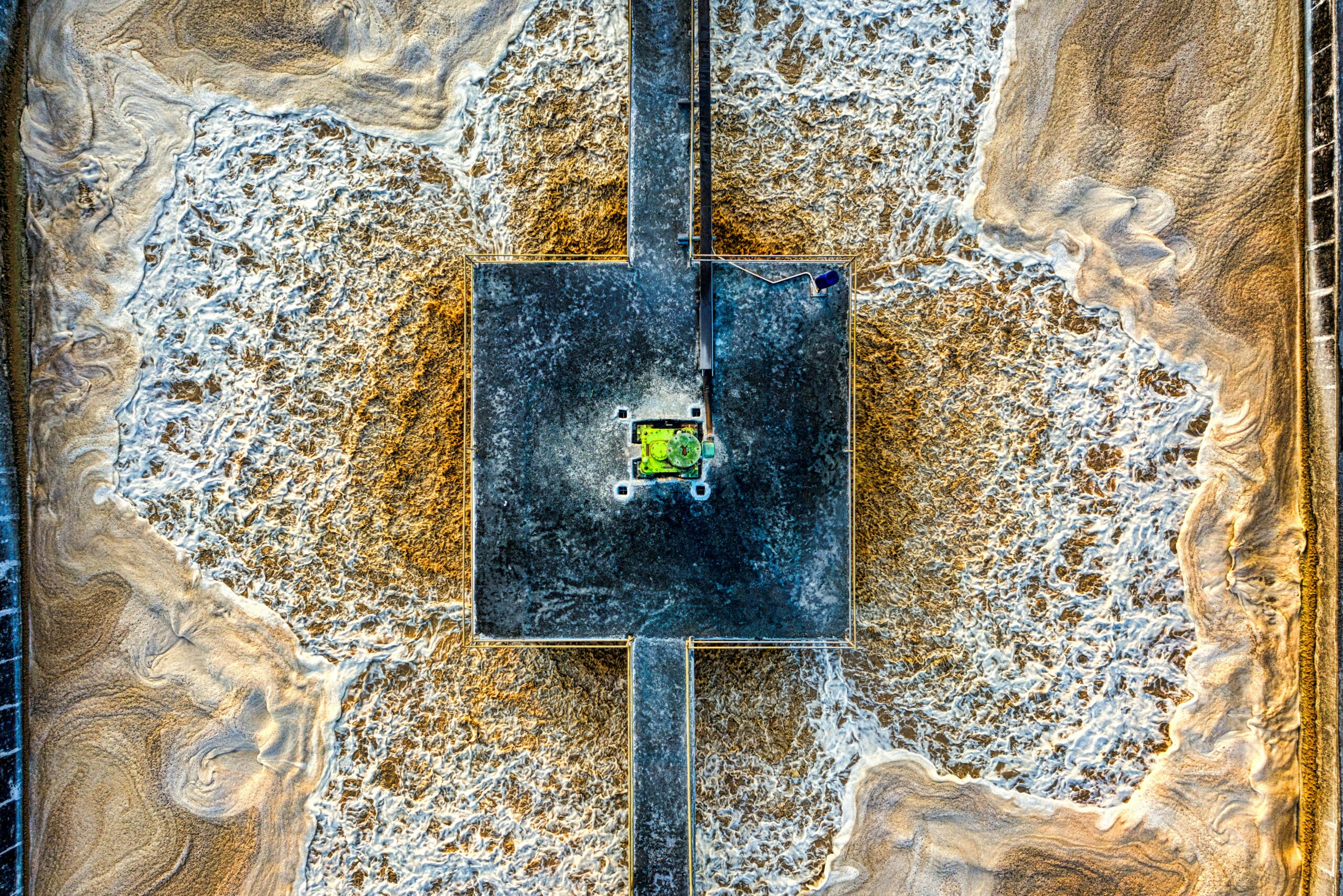 A wastewater treatment facility full of water from an aerial perspective.