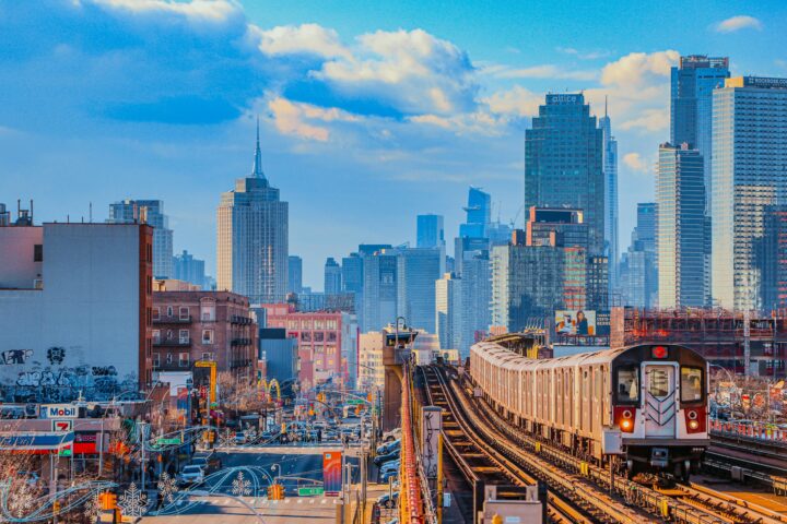 A train passes down elevated tracks in New York City.