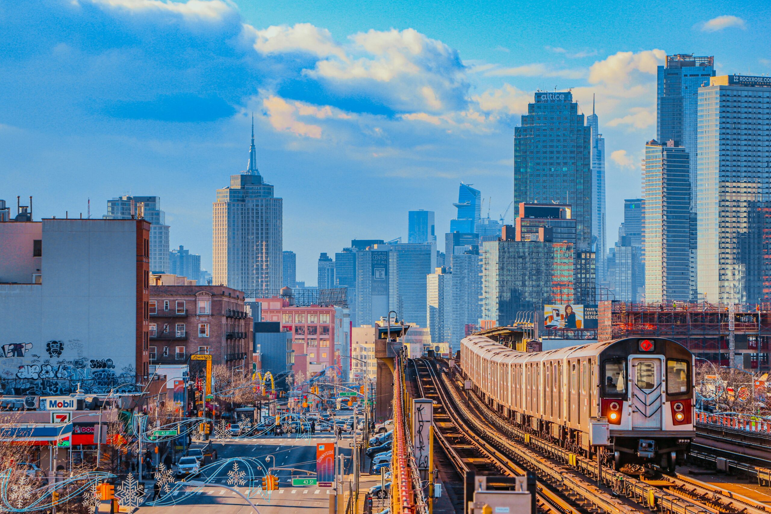 A train passes down elevated tracks in New York City.