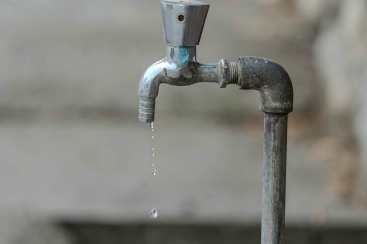 Water drips from a faucet.