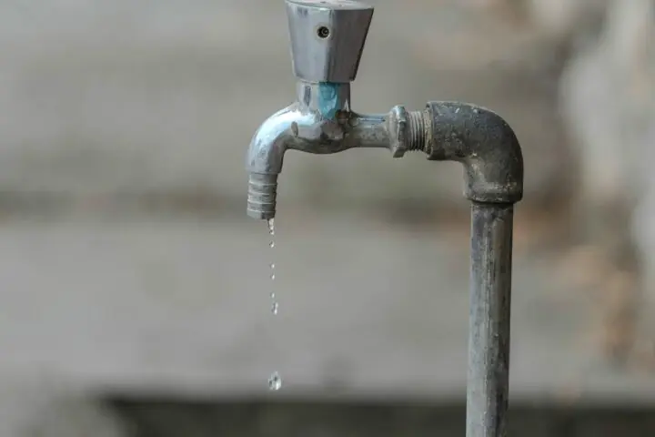 Water drips from a faucet.