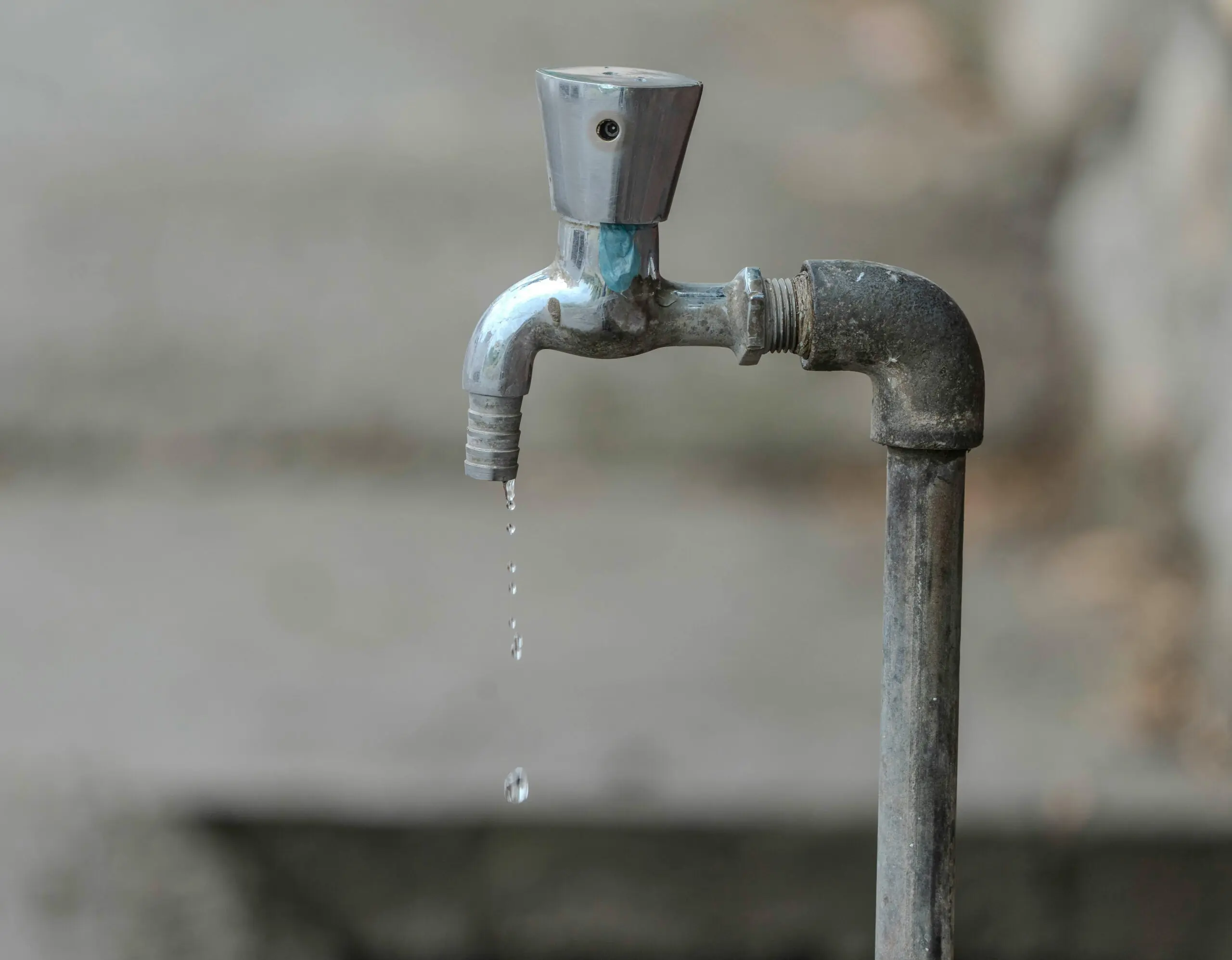 Water drips from a faucet.