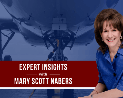 Mary Scott Nabers before a parked airplane for her weekly column about airport projects.