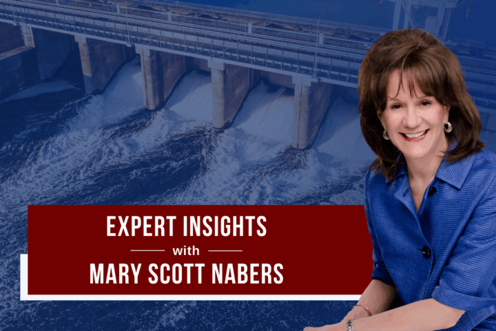 Mary Scott Nabers before a hydroelectric power plant for her weekly column.