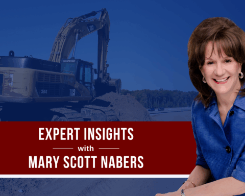 Mary Scott Nabers before a construction vehicle for her weekly column.