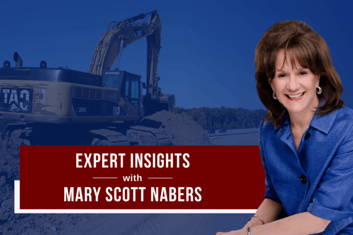 Mary Scott Nabers before a construction vehicle for her weekly column.