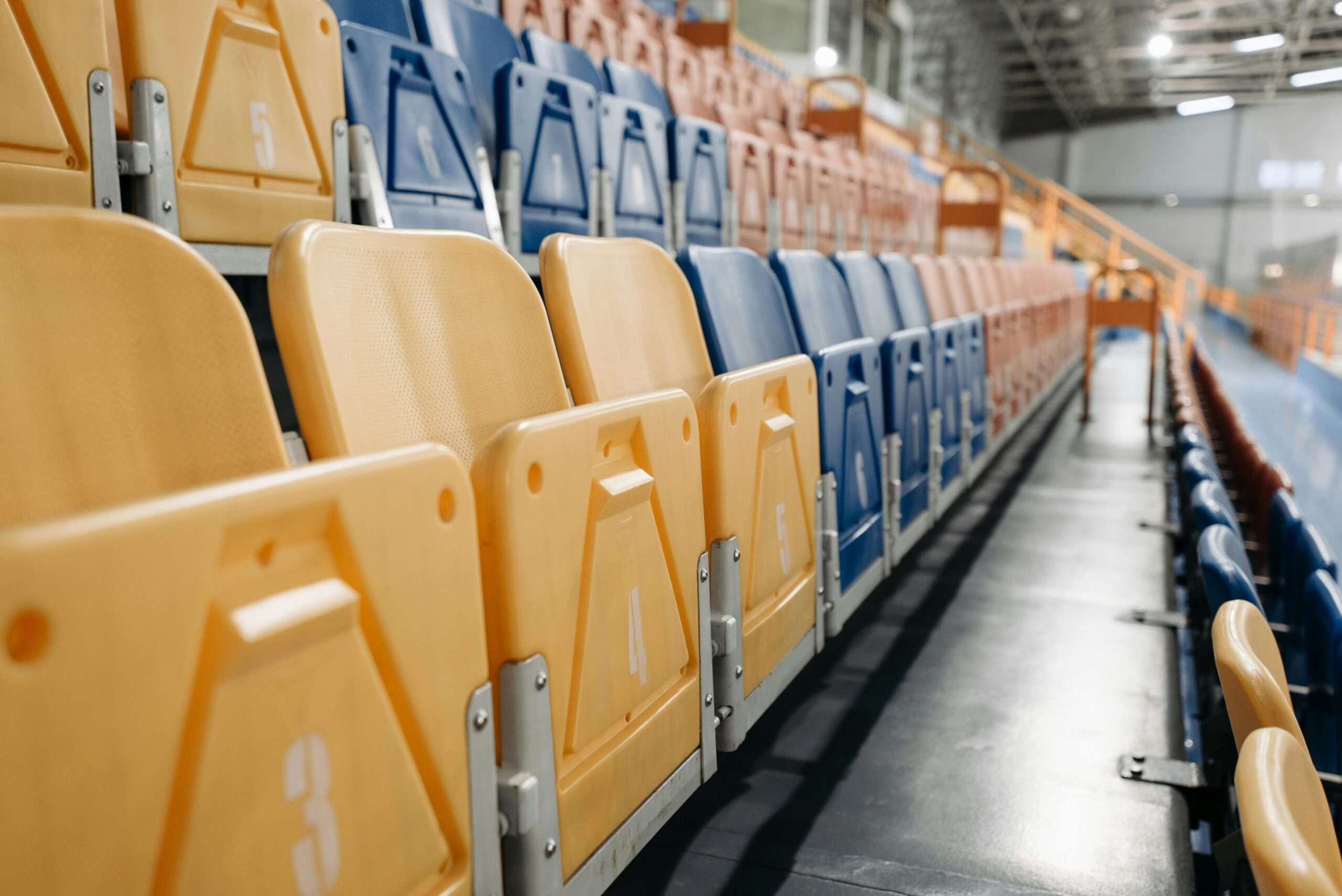 Multicolored arena seats in a basketball and volleyball arena.