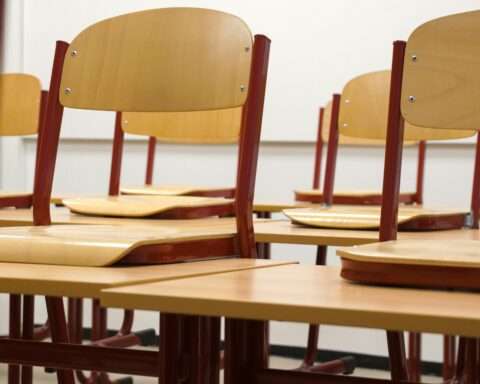 Classroom desks in a well-lit classroom.