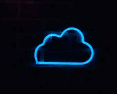 A neon blue cloud sign on a dark wall.