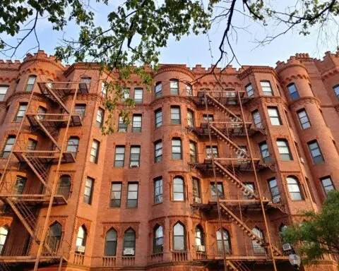 A tall, red brick housing development in Boston, Massachusetts.