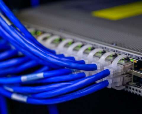 Blue broadband cables connect into a device.