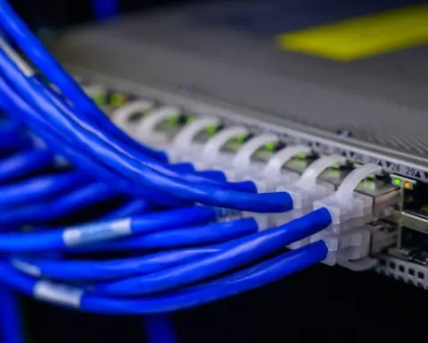 Blue broadband cables connect into a device.