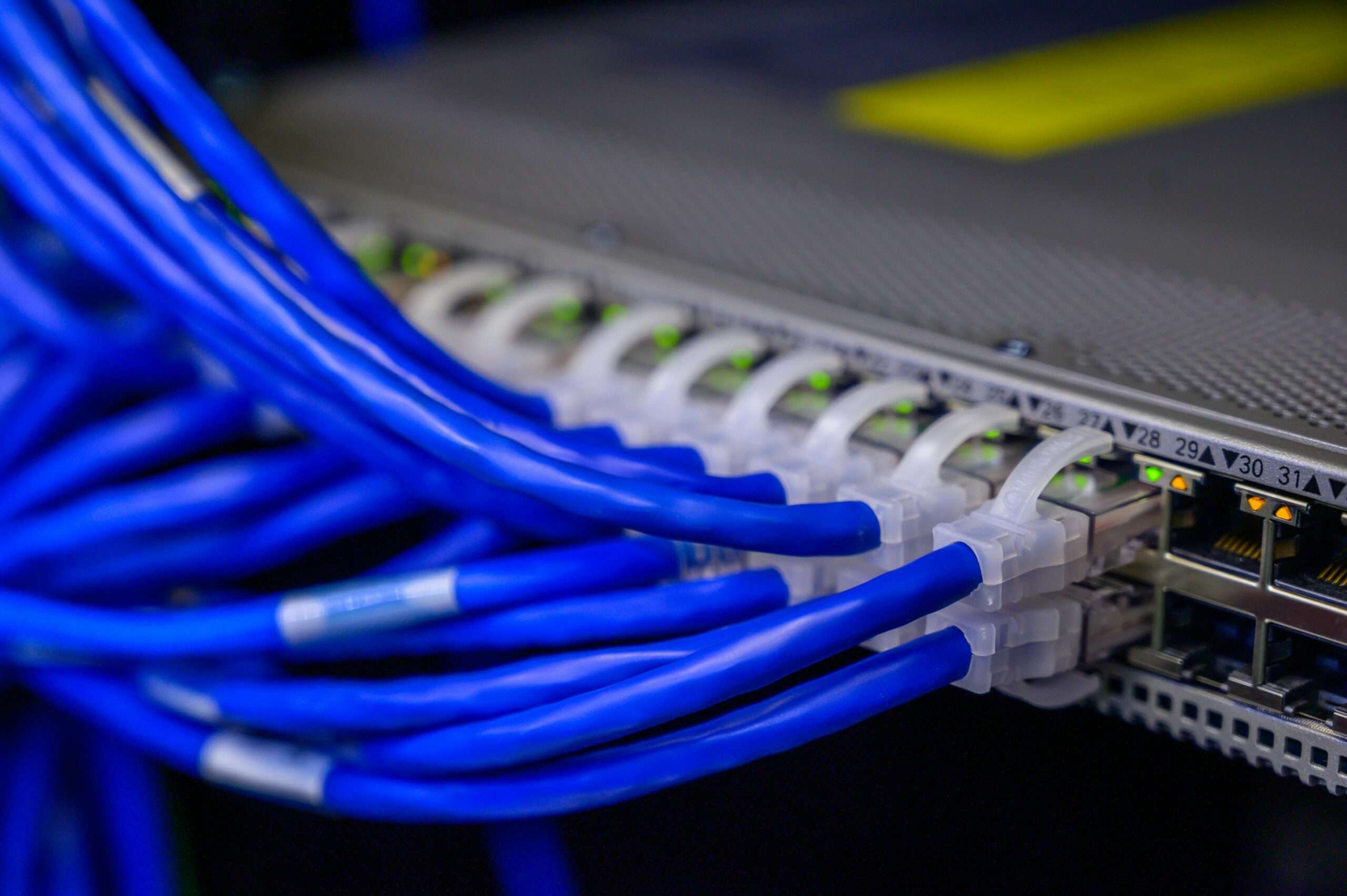 Blue broadband cables connect into a device.