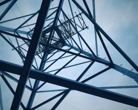 The underside of a electric transmission tower.