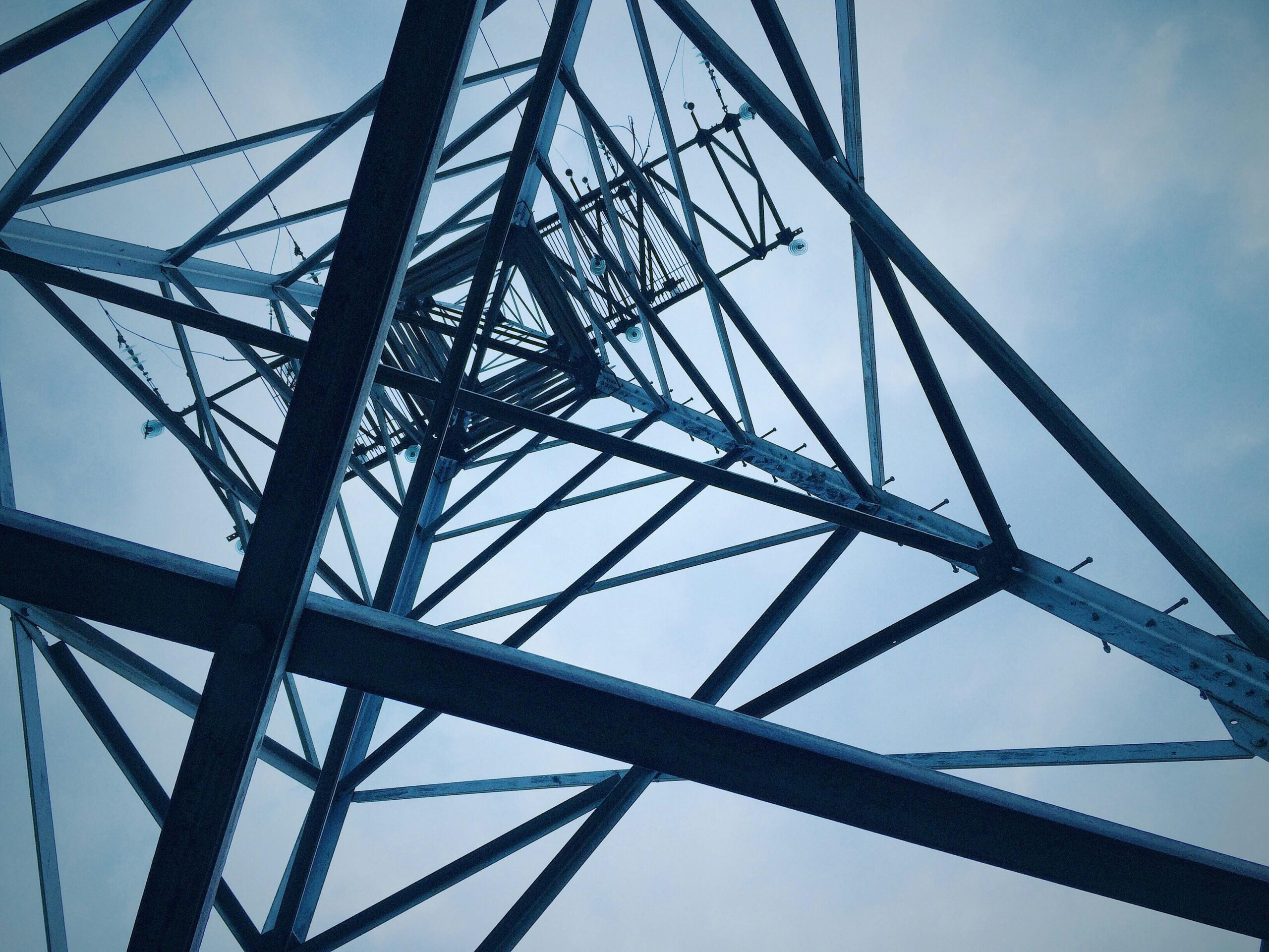 The underside of a electric transmission tower.