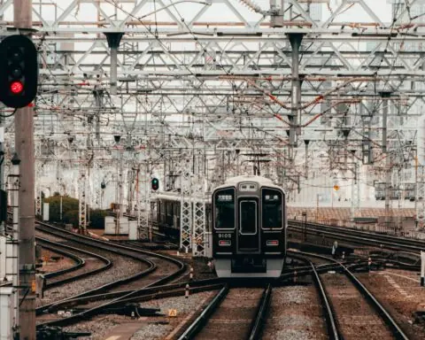 A rail corridor with a train on the tracks.