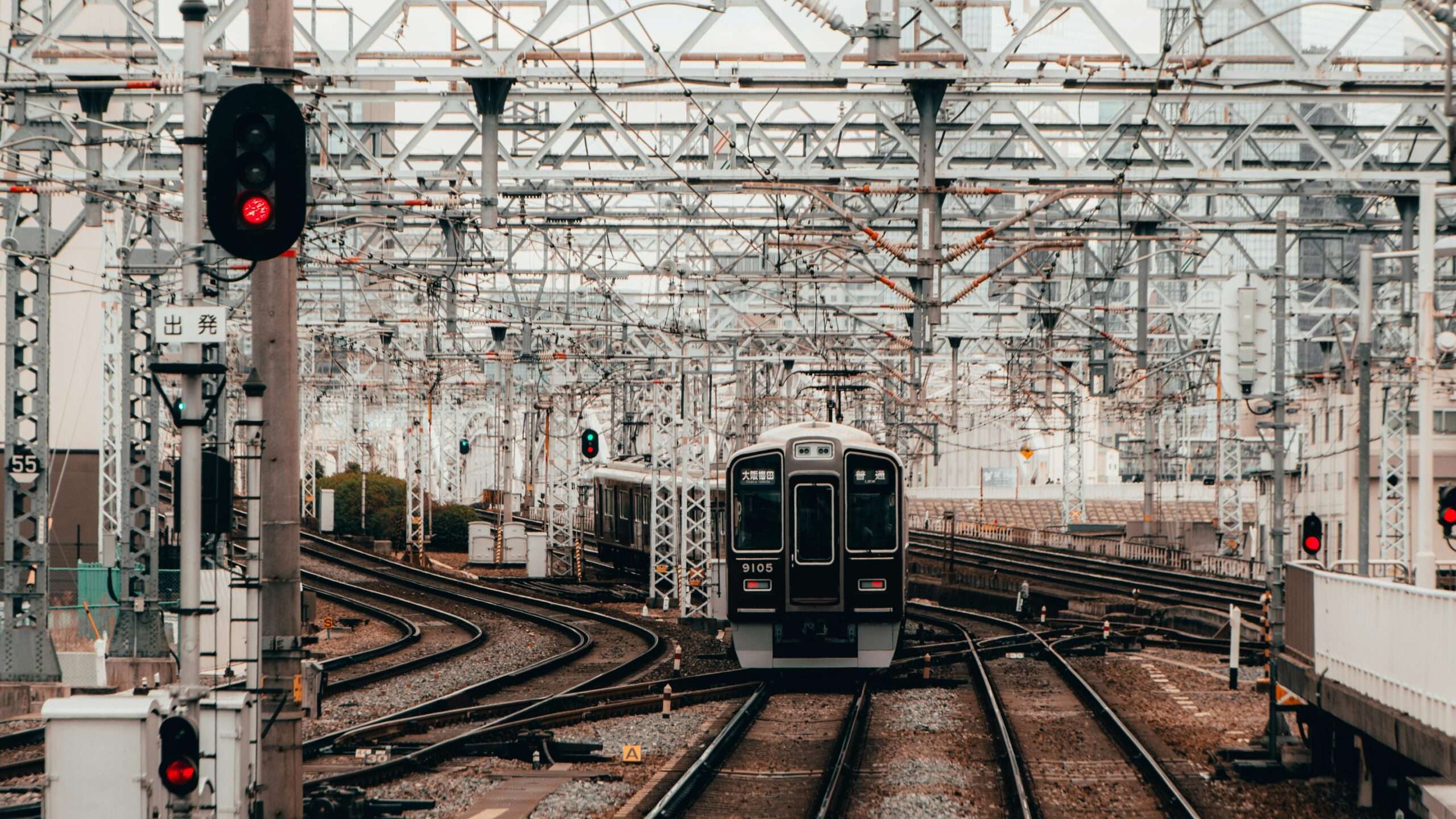 A rail corridor with a train on the tracks.