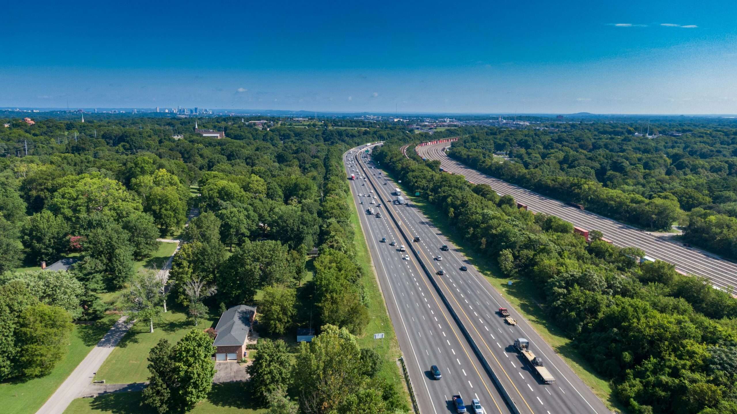 An aerial view of an American highway with cars and semi trucks on the road.