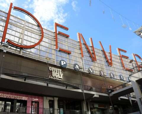 A sign indicating you are at the Denver Pavilions in Denver, Colorado, from the ground.