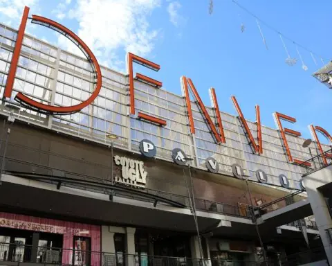 A sign indicating you are at the Denver Pavilions in Denver, Colorado, from the ground.
