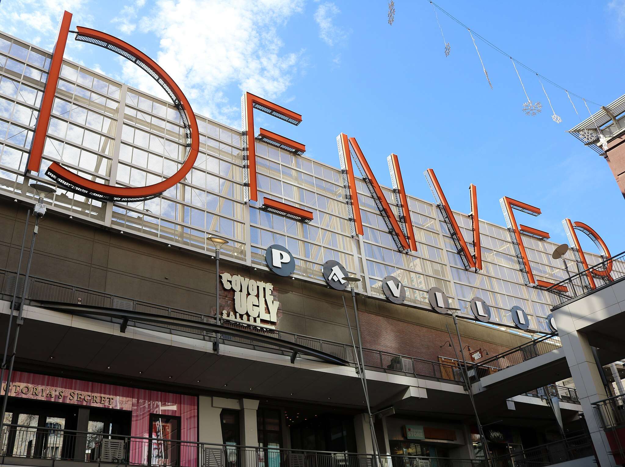 A sign indicating you are at the Denver Pavilions in Denver, Colorado, from the ground.