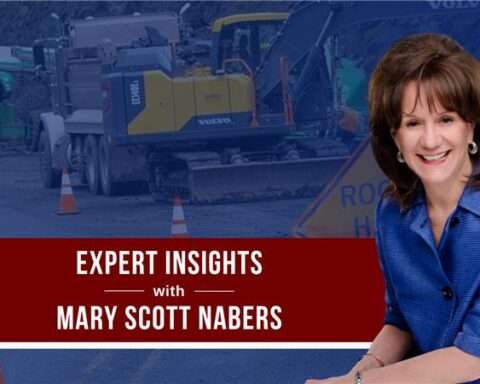 Mary Scott Nabers before roadway construction equipment for her weekly colulmn.