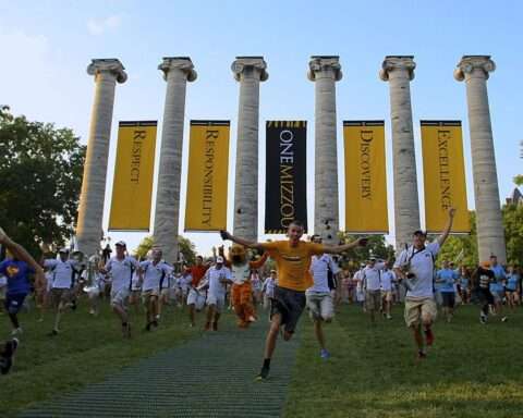 Students run through pillars at the University of Missouri.