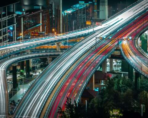 A timelapse photo of cars and trucks traveling along highways and arterials from above.