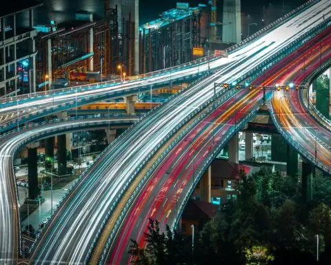 A timelapse photo of cars and trucks traveling along highways and arterials from above.