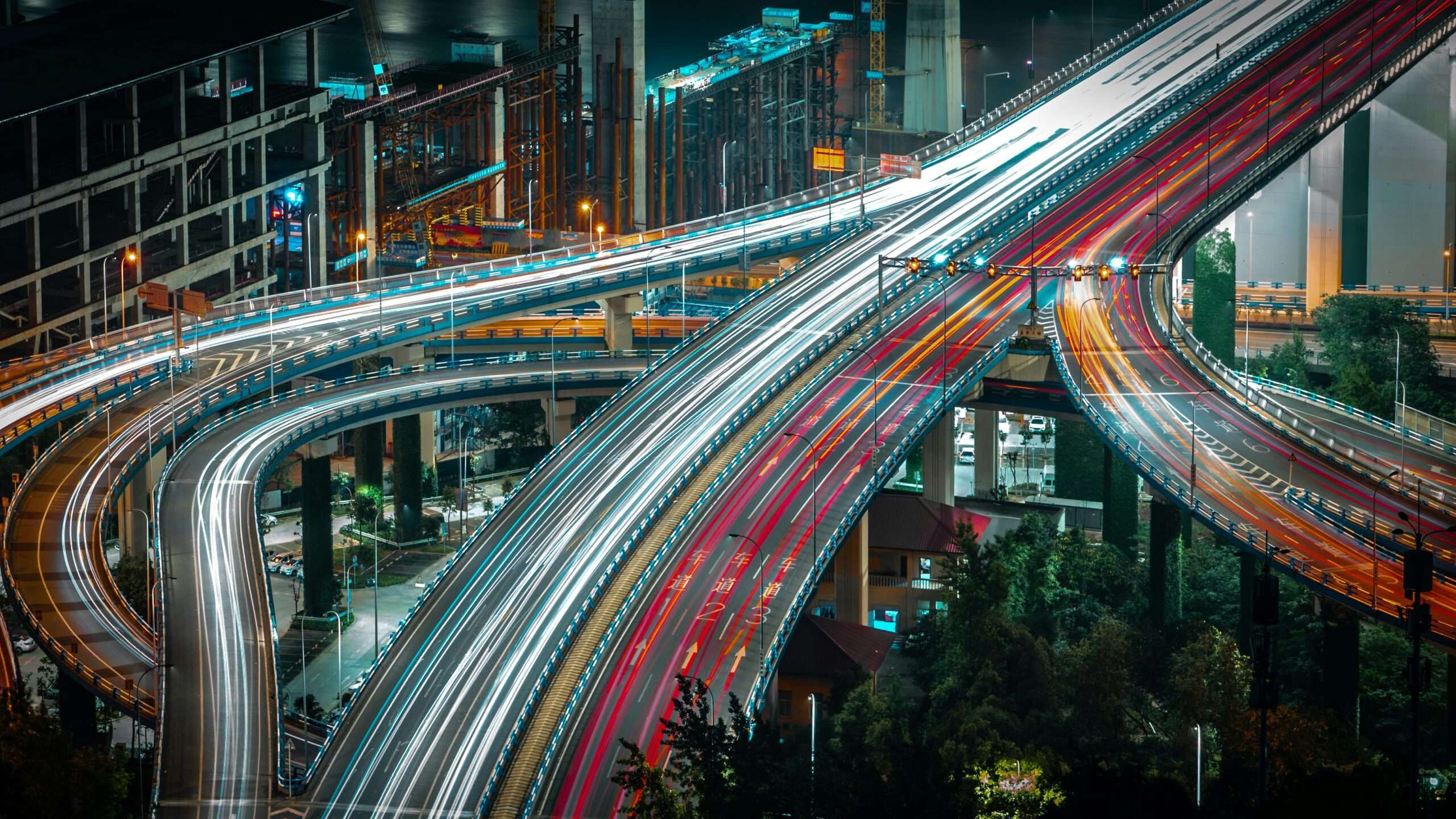 A timelapse photo of cars and trucks traveling along highways and arterials from above.