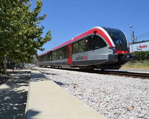 A CapMetro train passes down a railway in Austin.