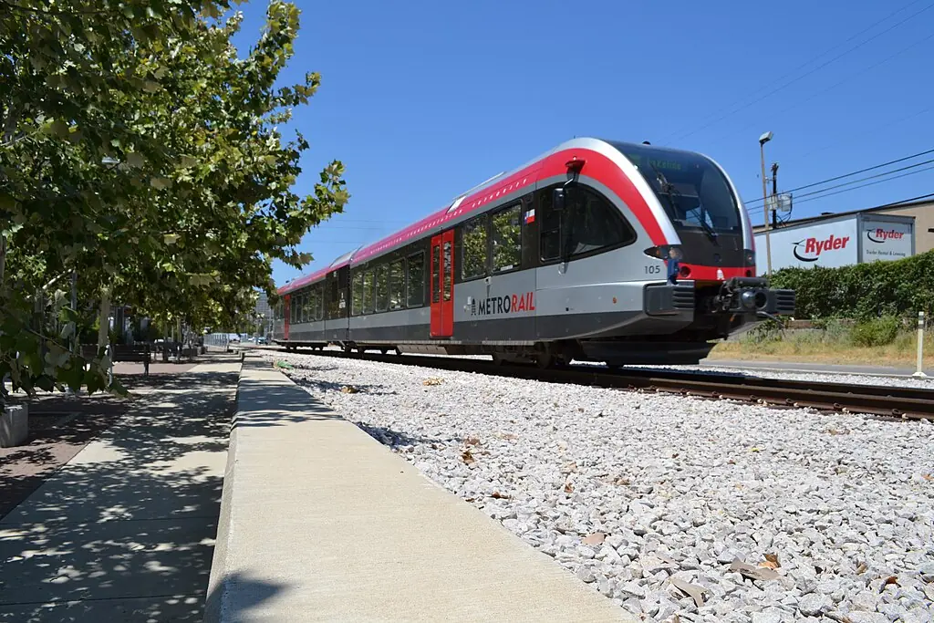 A CapMetro train passes down a railway in Austin.