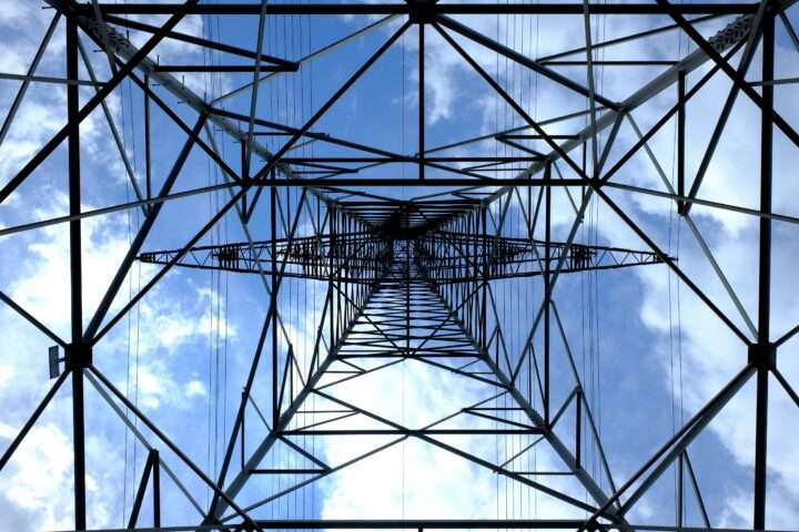 The underside of a electric transmission tower.