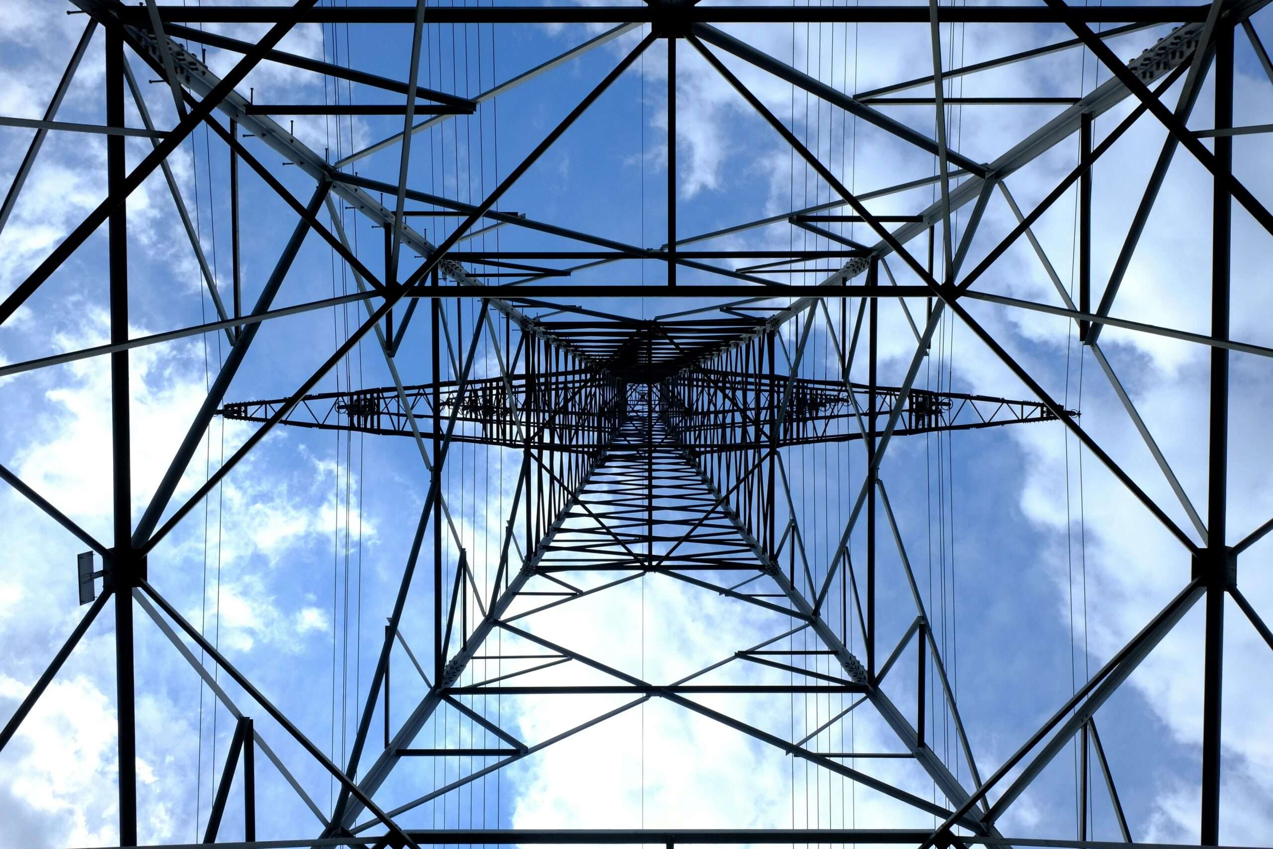 The underside of a electric transmission tower.