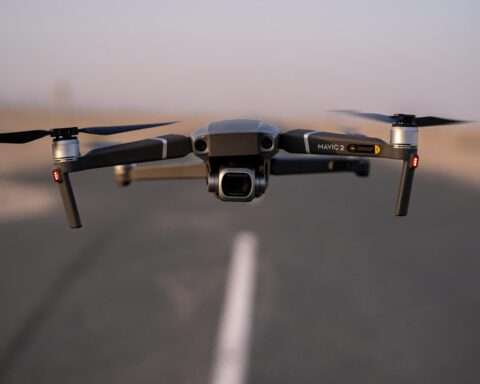 A hovering drone along a roadway.