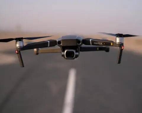 A hovering drone along a roadway.