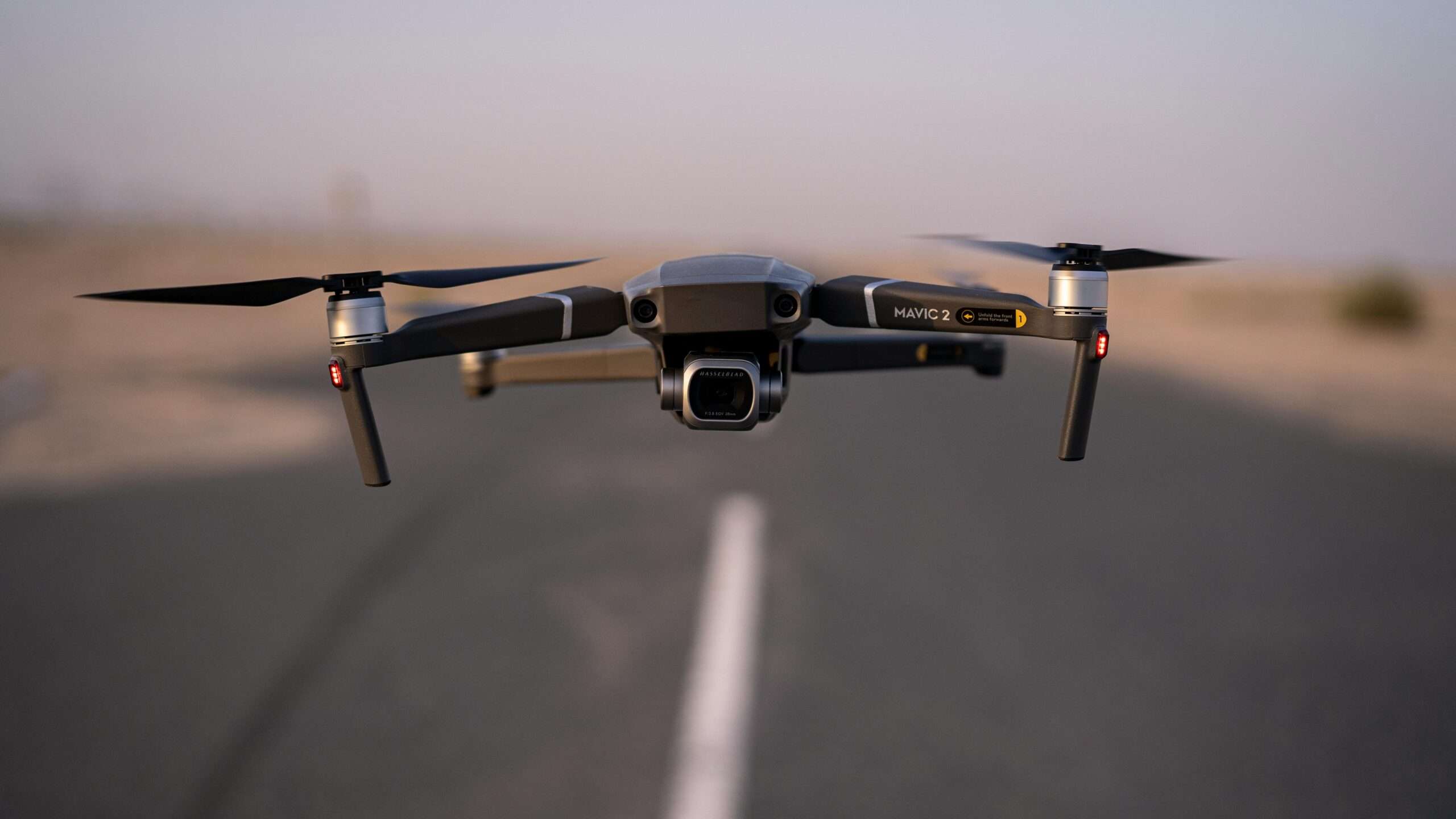 A hovering drone along a roadway.