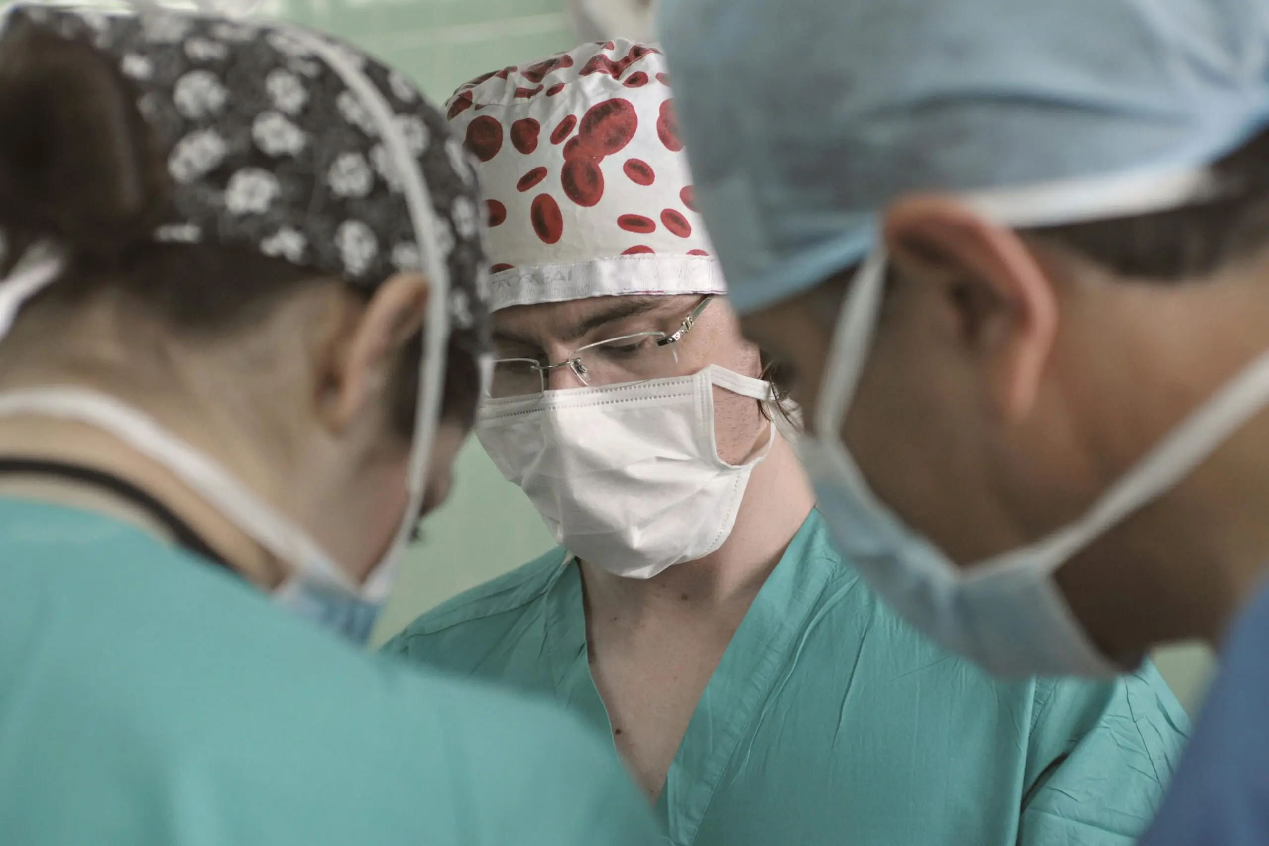 Three medical professionals stand among each other.