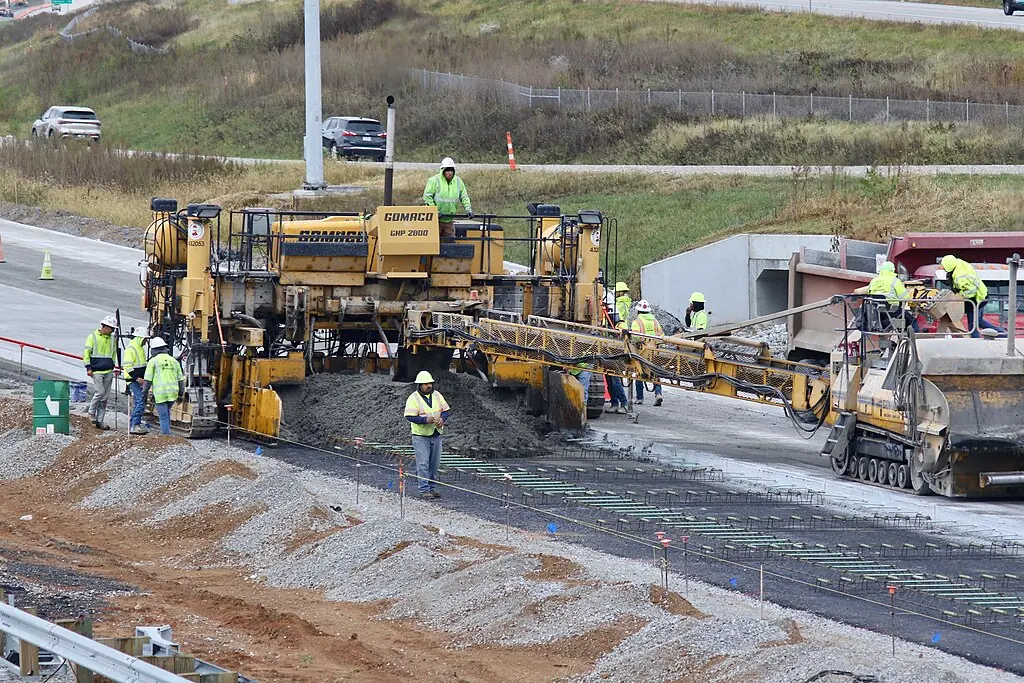 A paving machine along a highway.