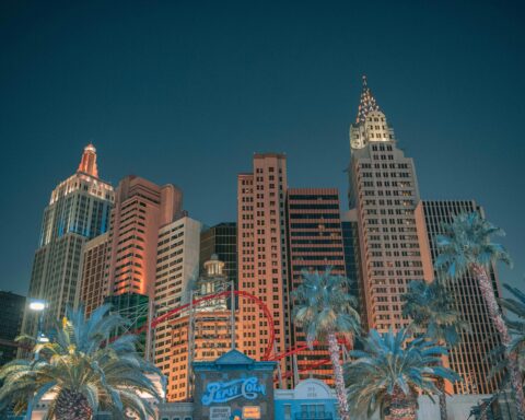 The Las Vegas skyline from the ground against a dark night sky.
