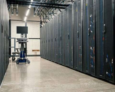 A hallway in between data center stacks in a clean building.
