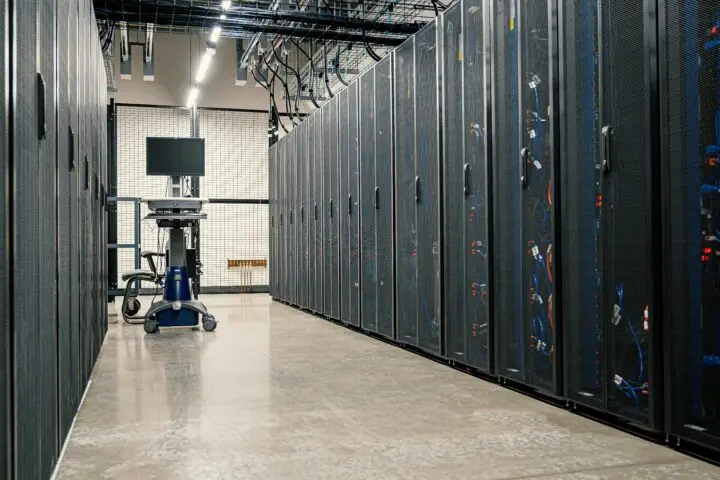 A hallway in between data center stacks in a clean building.