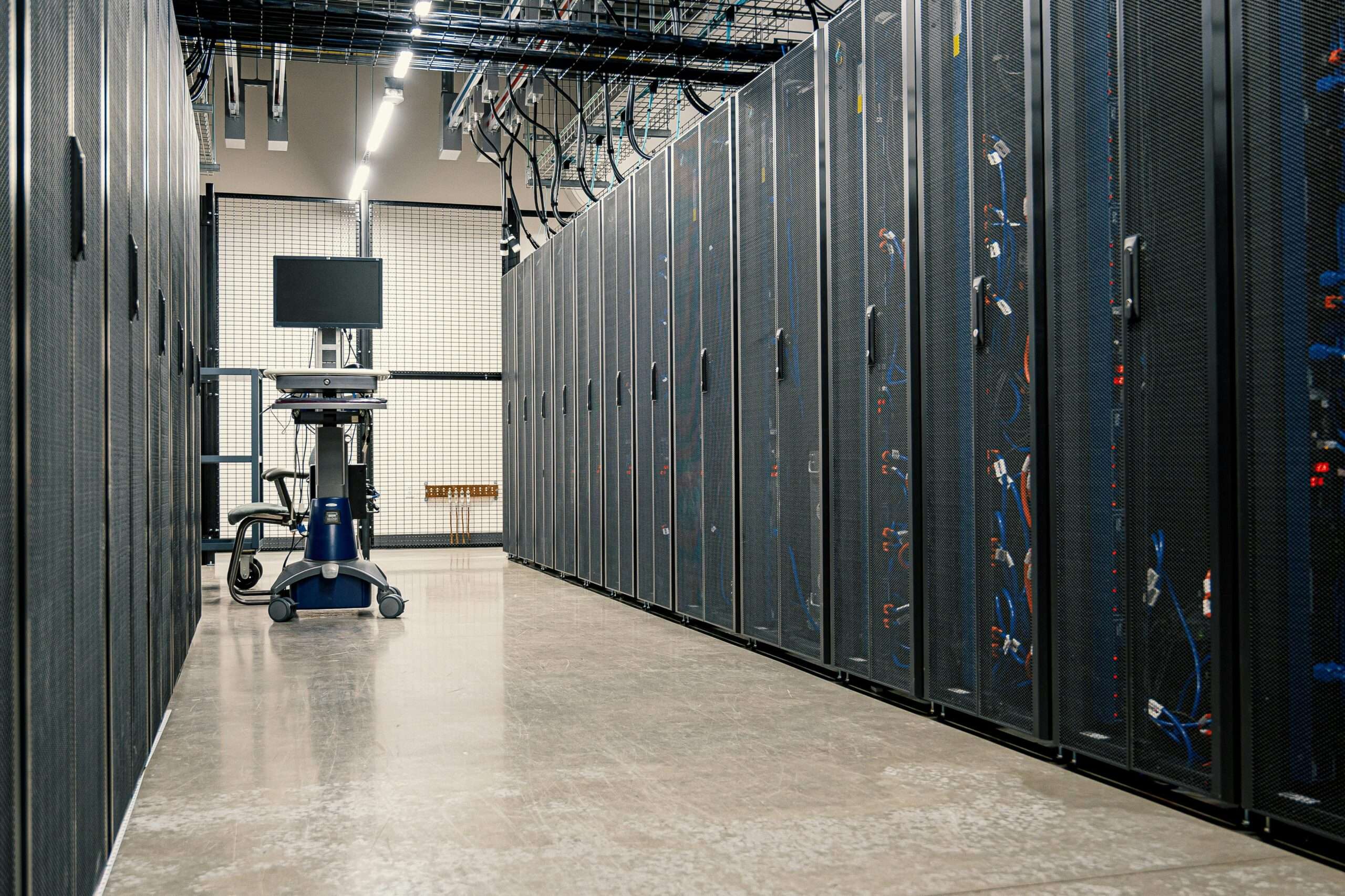 A hallway in between data center stacks in a clean building.