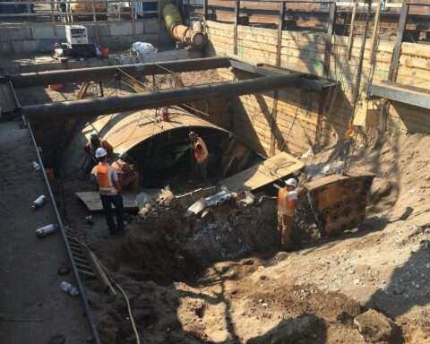Workers with a tunnel boring machine construct a tunnel in New York City.