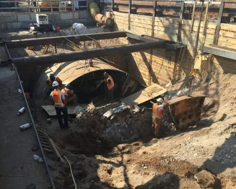Workers with a tunnel boring machine construct a tunnel in New York City.