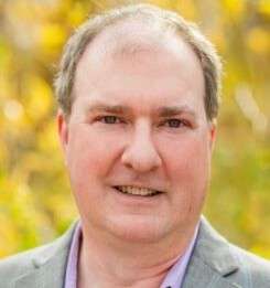 A portrait of Aaron Brockett.